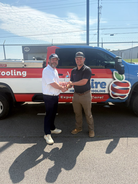 Dylan Terry greeting a local business partner beside the Apple Aire Alabama truck